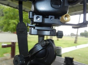 closeup of main setscrew to adjust rail (gold) and QR plate from baseplate to tripod mount