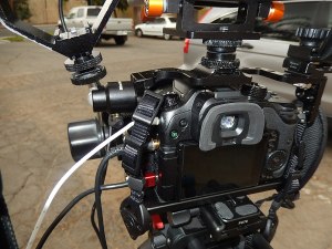 rear view of GH4 in cage with attachment points and follow focus visible